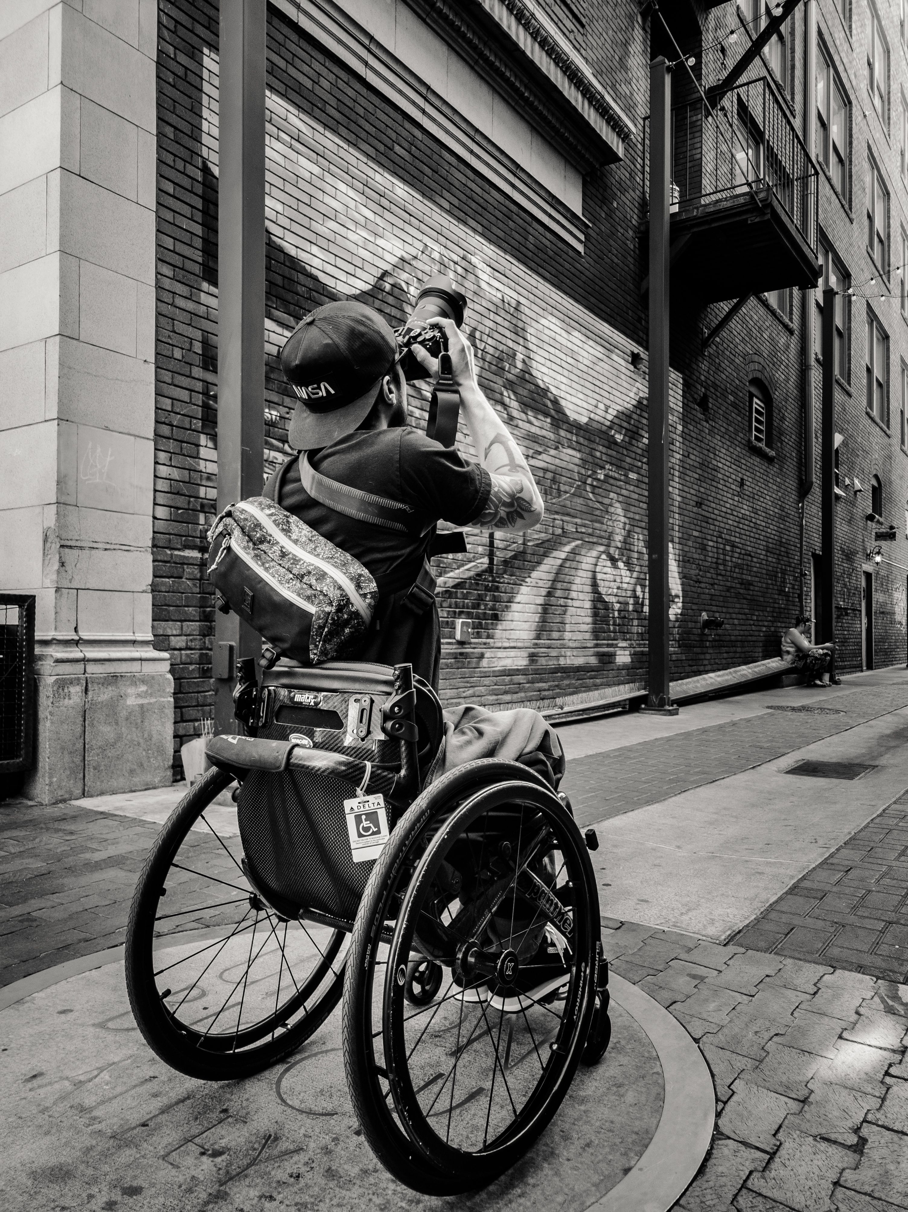 Man on a Wheelchair Photographing the Street in Black and White · Free ...