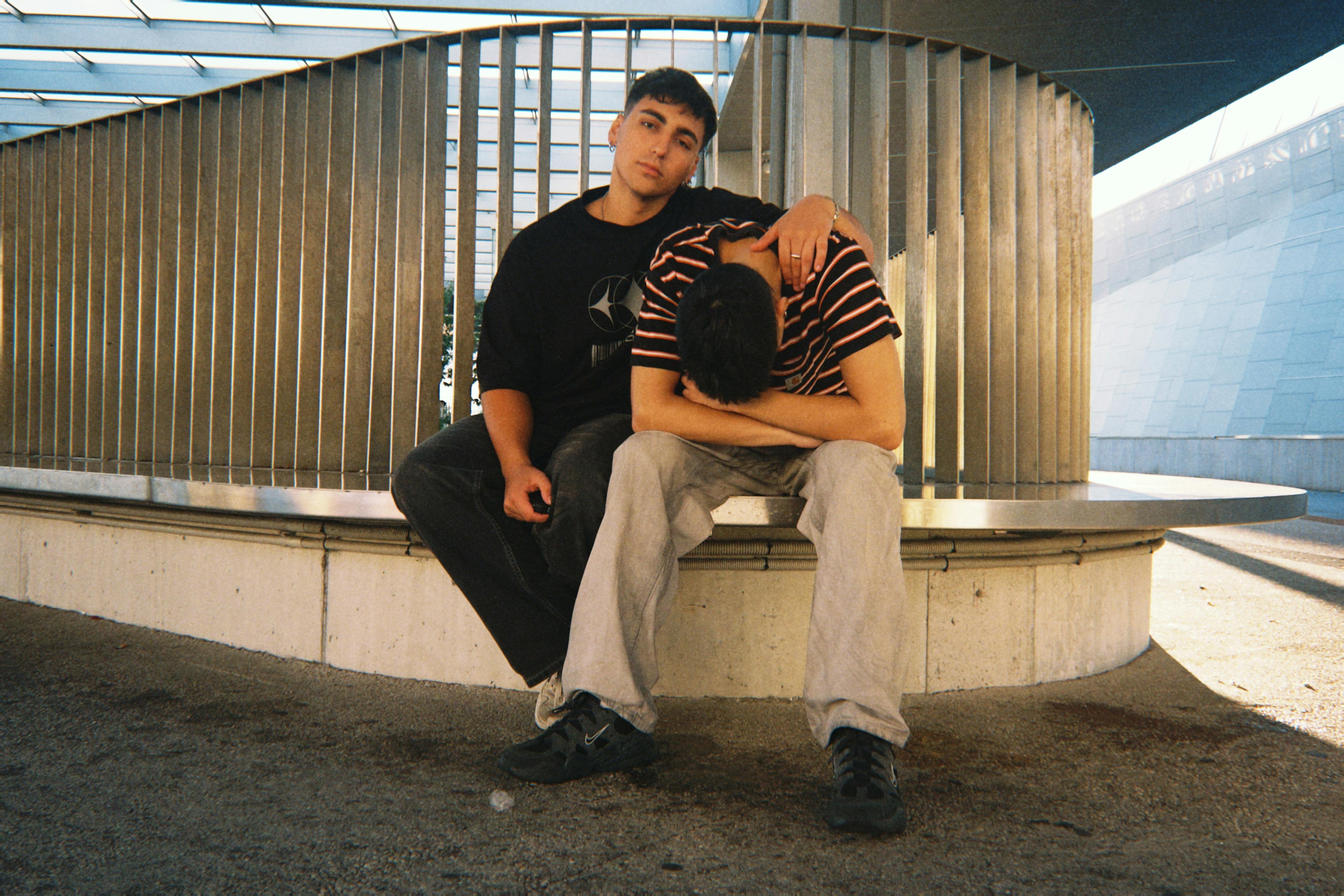 two men sitting on a bench