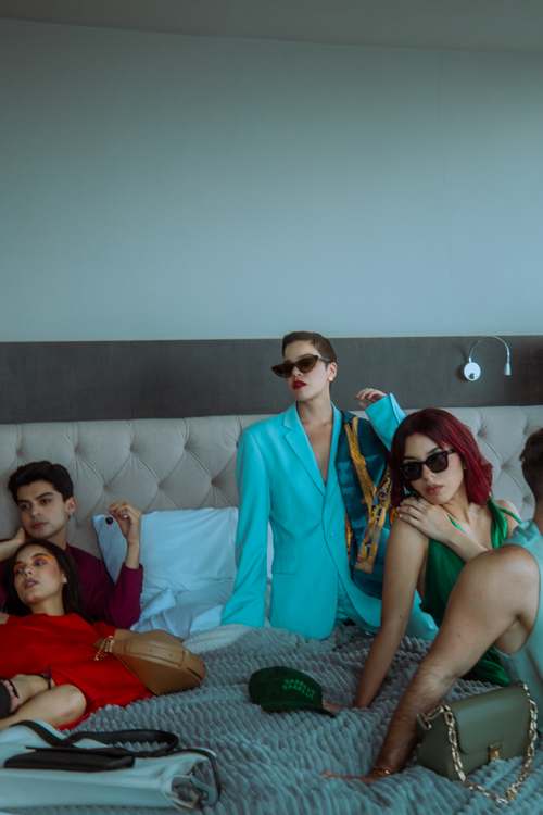 Free Group of fashionable adults relaxing on a bed in a modern room, Ciudad de México. Stock Photo