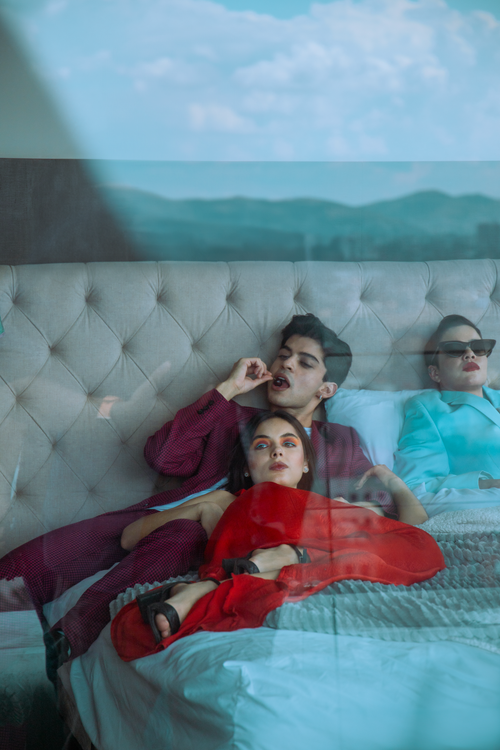 Free Stylish adults relaxing on a hotel bed in Ciudad de México, showcasing modern fashion. Stock Photo