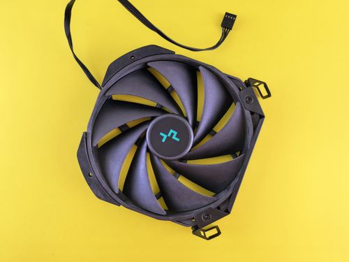 Free Studio shot of a black computer cooling fan on a vivid yellow backdrop. Stock Photo