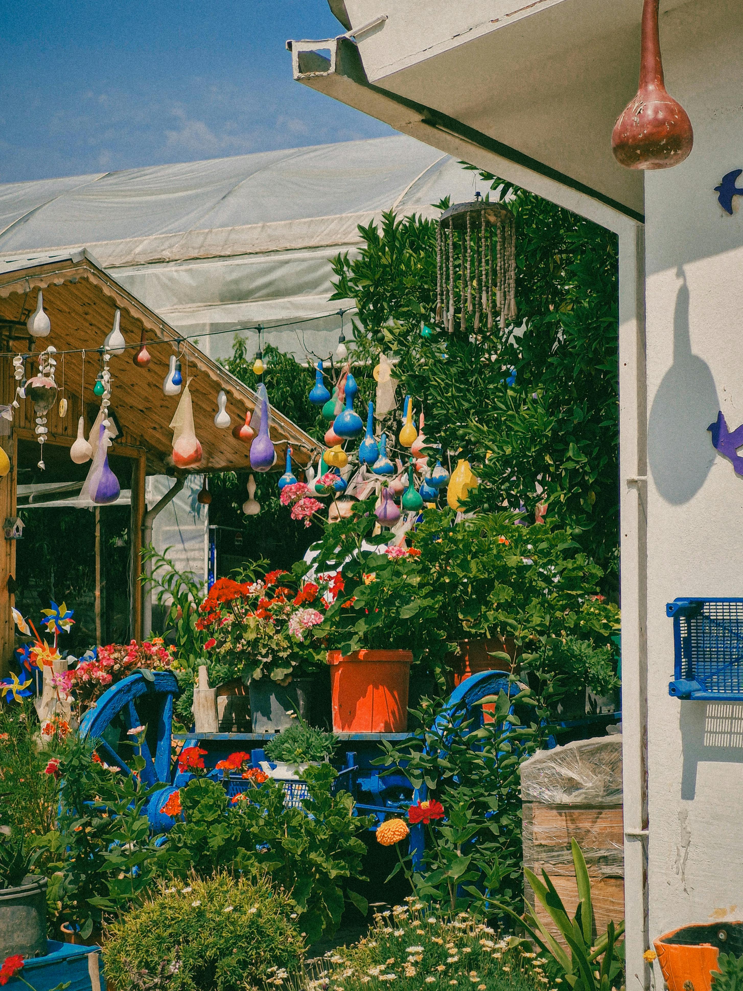 Colorful garden with flowers and traditional Turkish ornaments in a sunny, vibrant setting.