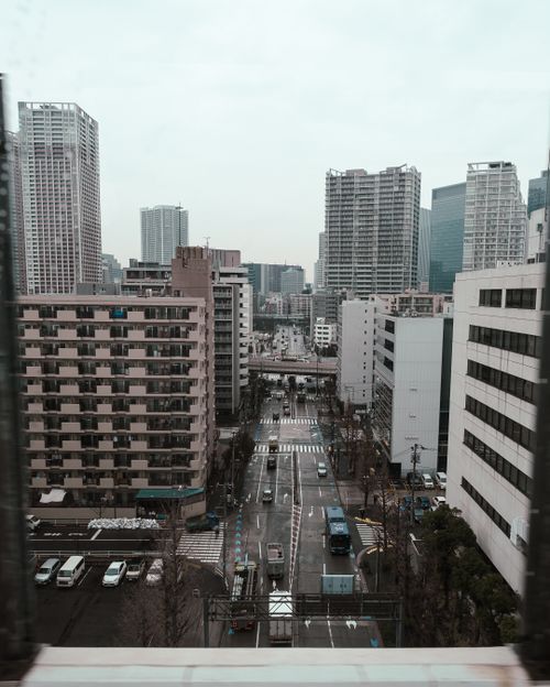 Free View of a modern urban cityscape featuring skyscrapers and a busy street. Stock Photo