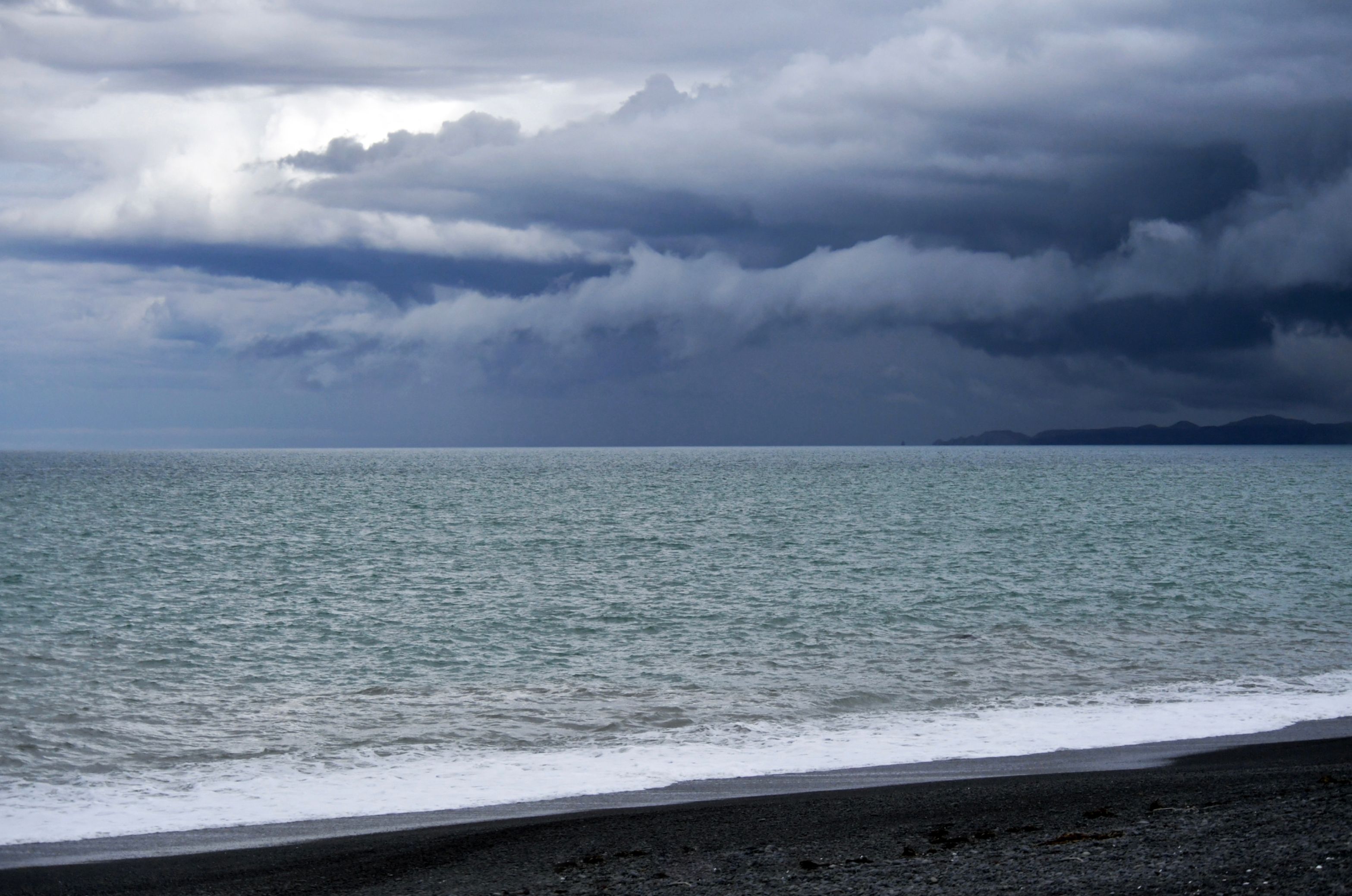 A stormy sky over the ocean and a beach · Free Stock Photo