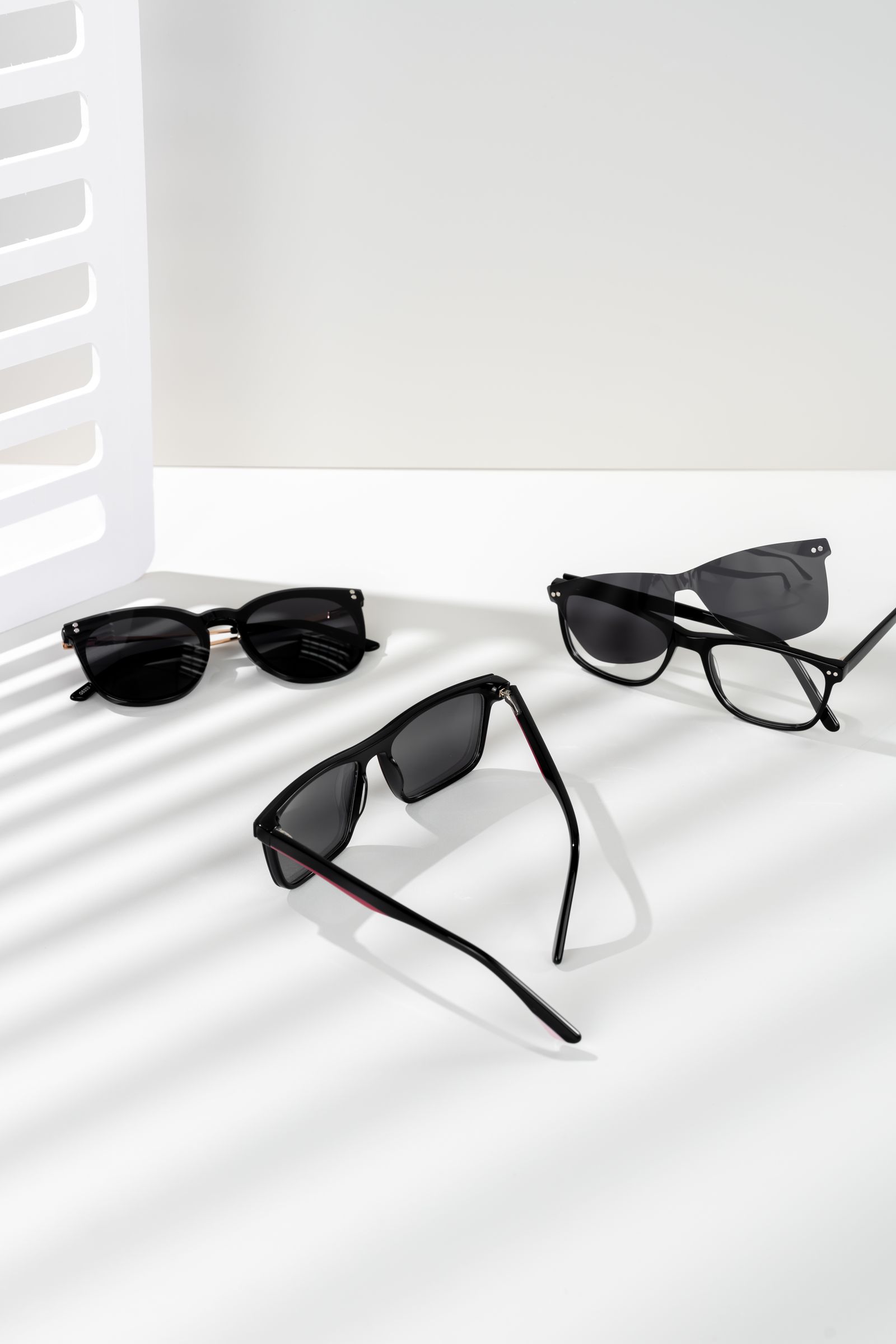 Sunglasses on a white surface with soft shadows