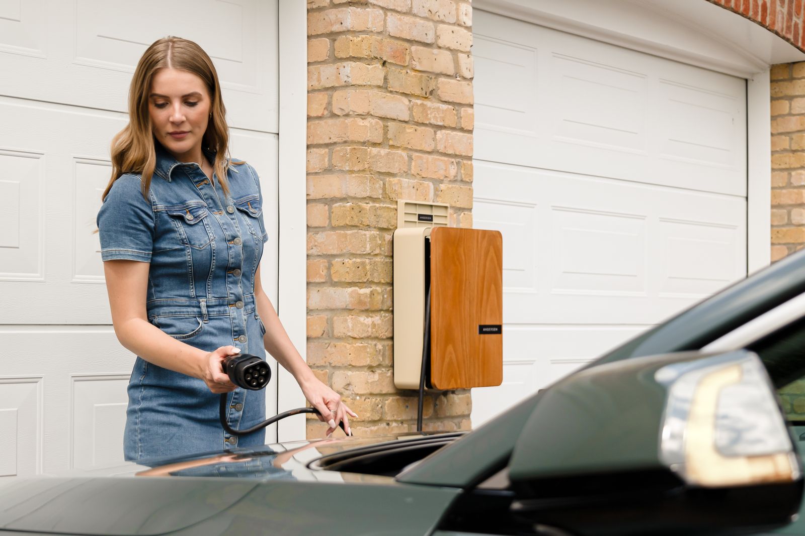 Electric car plugged into a home charger, illustrating solar and EV charging in Scotland