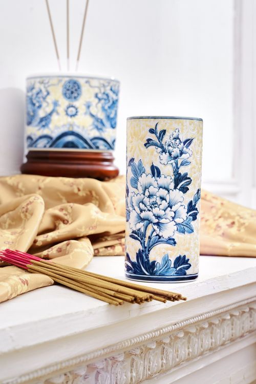 Free Intricately designed ceramic vase with blue floral patterns beside incense sticks indoors. Stock Photo