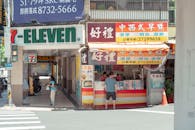 A man walking down the street in front of a chinese restaurant