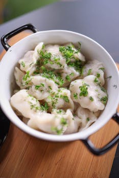 Delicious homemade dumplings served in a bowl, garnished with fresh parsley for a traditional taste.