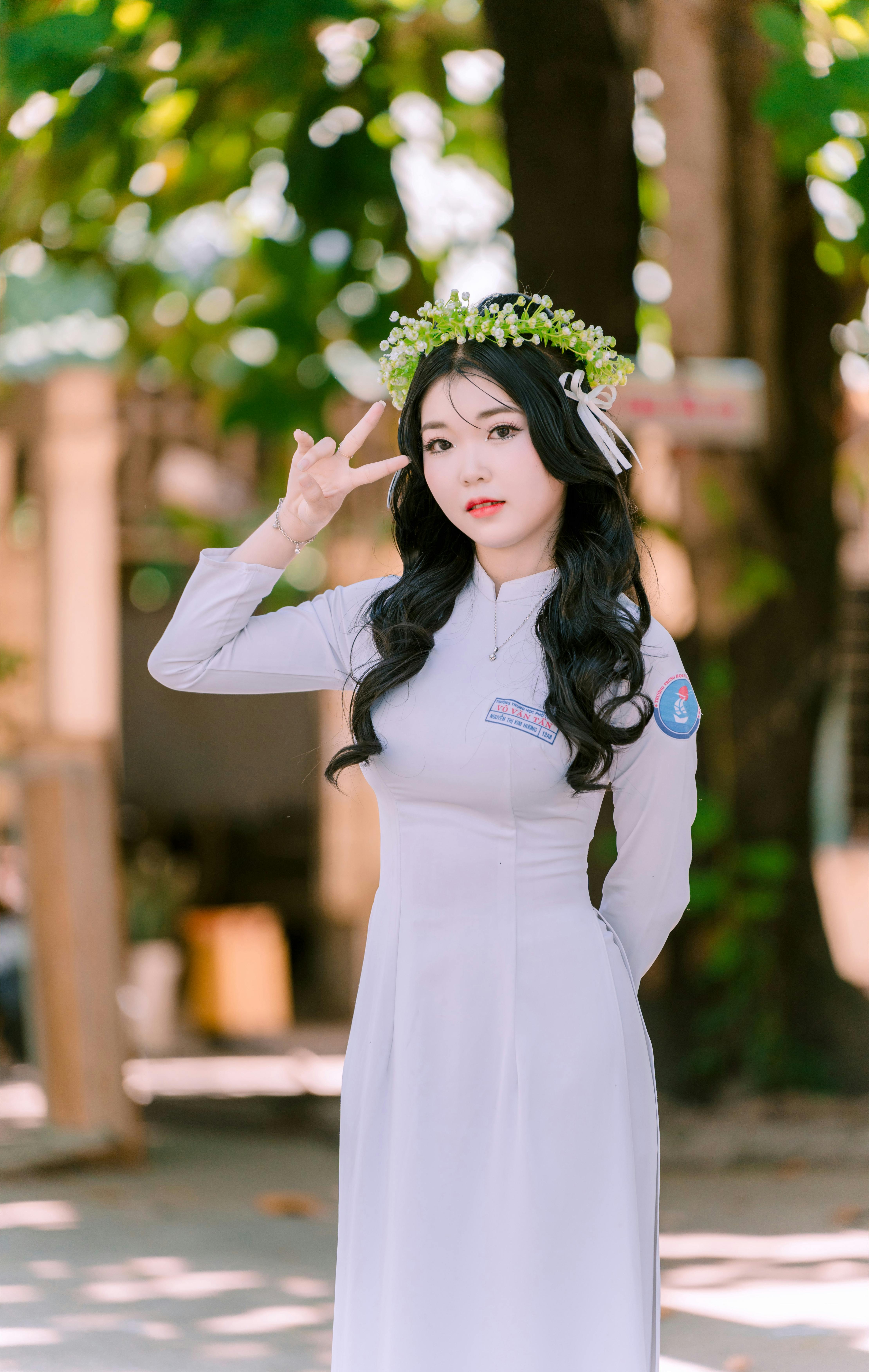 a woman in a white dress and flower crown