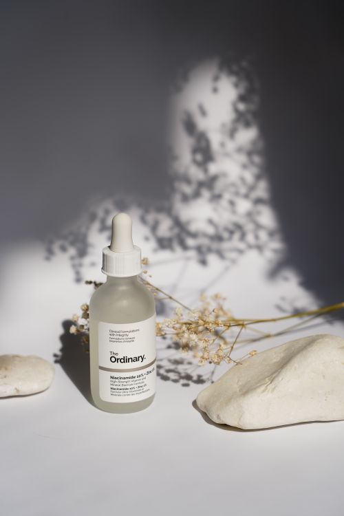 Free A minimalist still life of skincare serum bottle with natural shadows. Stock Photo