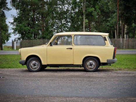 Classic Trabant car parked beside a lush green forest in Kalmaküla, Jõgeva County, Estonia.