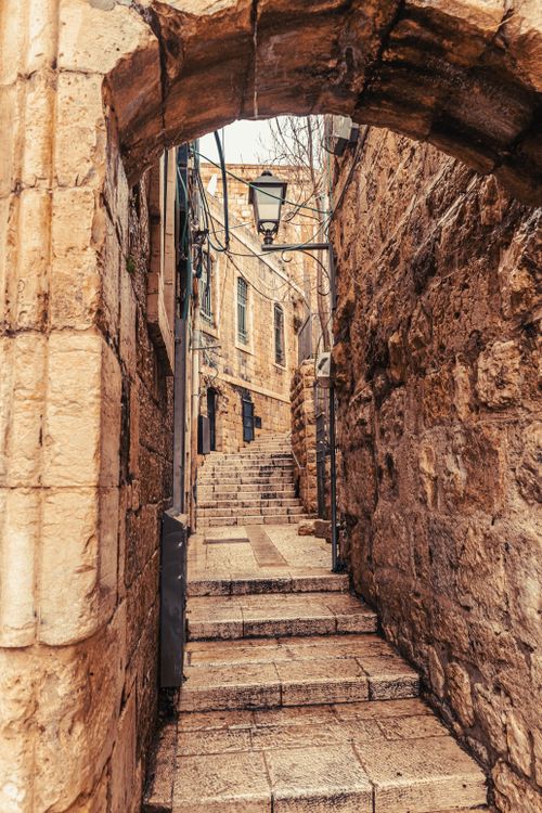 Free Explore the narrow stone alleys and arches of Jerusalem's Old City, a step back in architectural history. Stock Photo