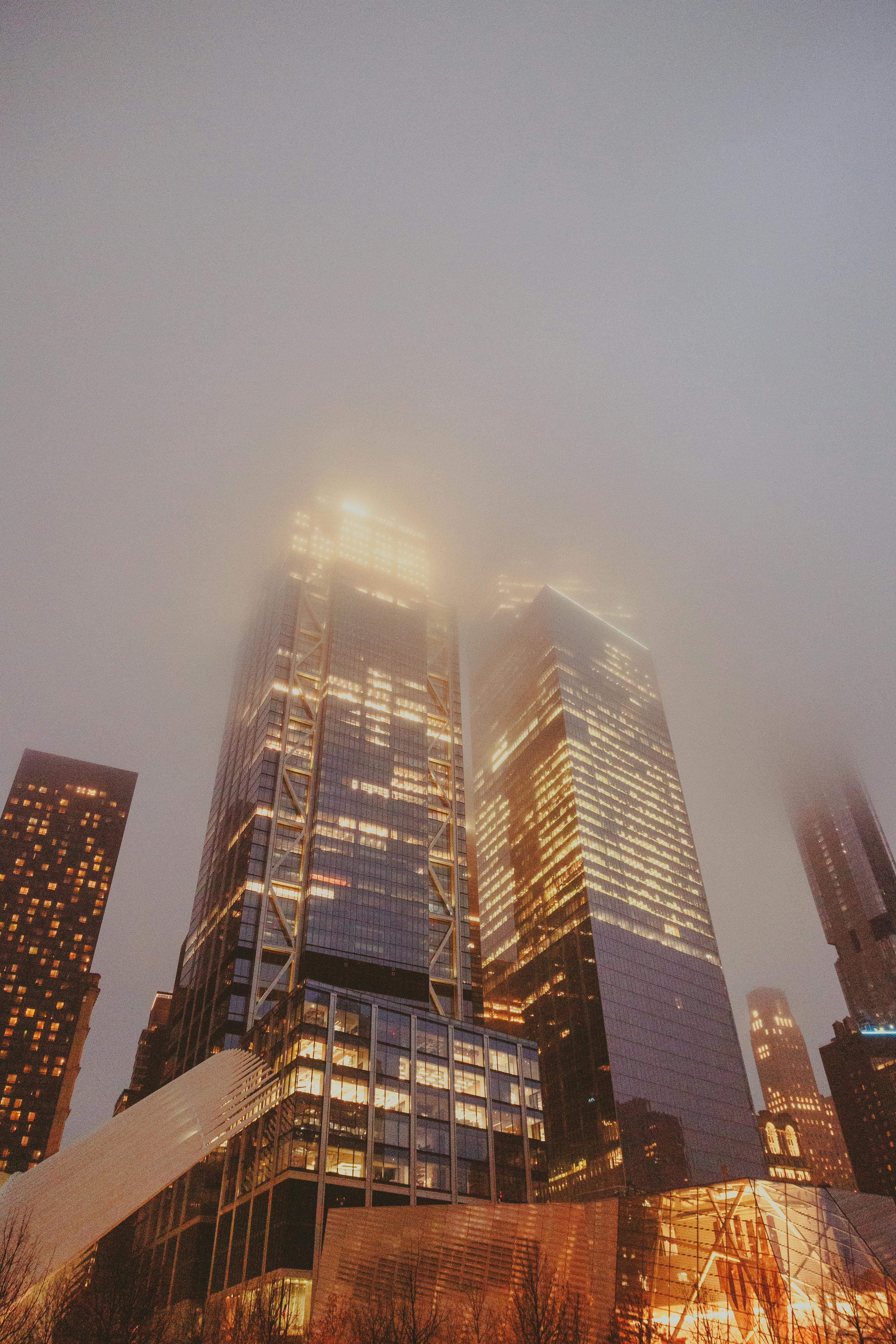 cloudy night in with bright lights from skyscrapers in downtown ny