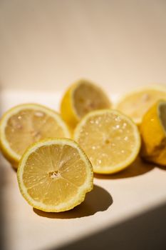 Sunlit lemon slices casting shadows, highlighting their juicy texture and vibrant color.