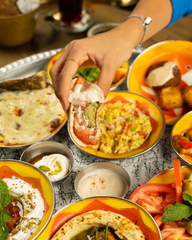 A vibrant Middle Eastern mezze platter featuring hummus, falafel, and fresh vegetables.