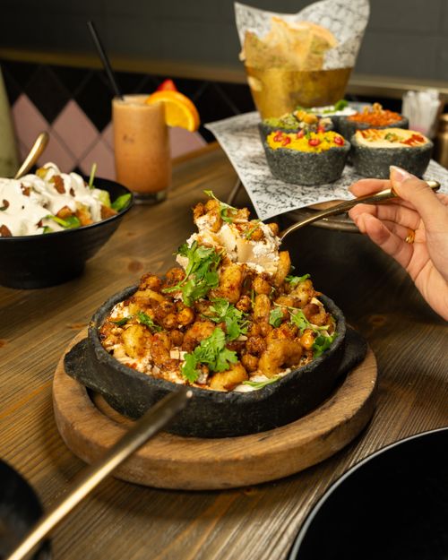 Free A delicious vegetarian dish served with fresh ingredients in a cozy atmosphere, perfect for dinner or lunch. Stock Photo