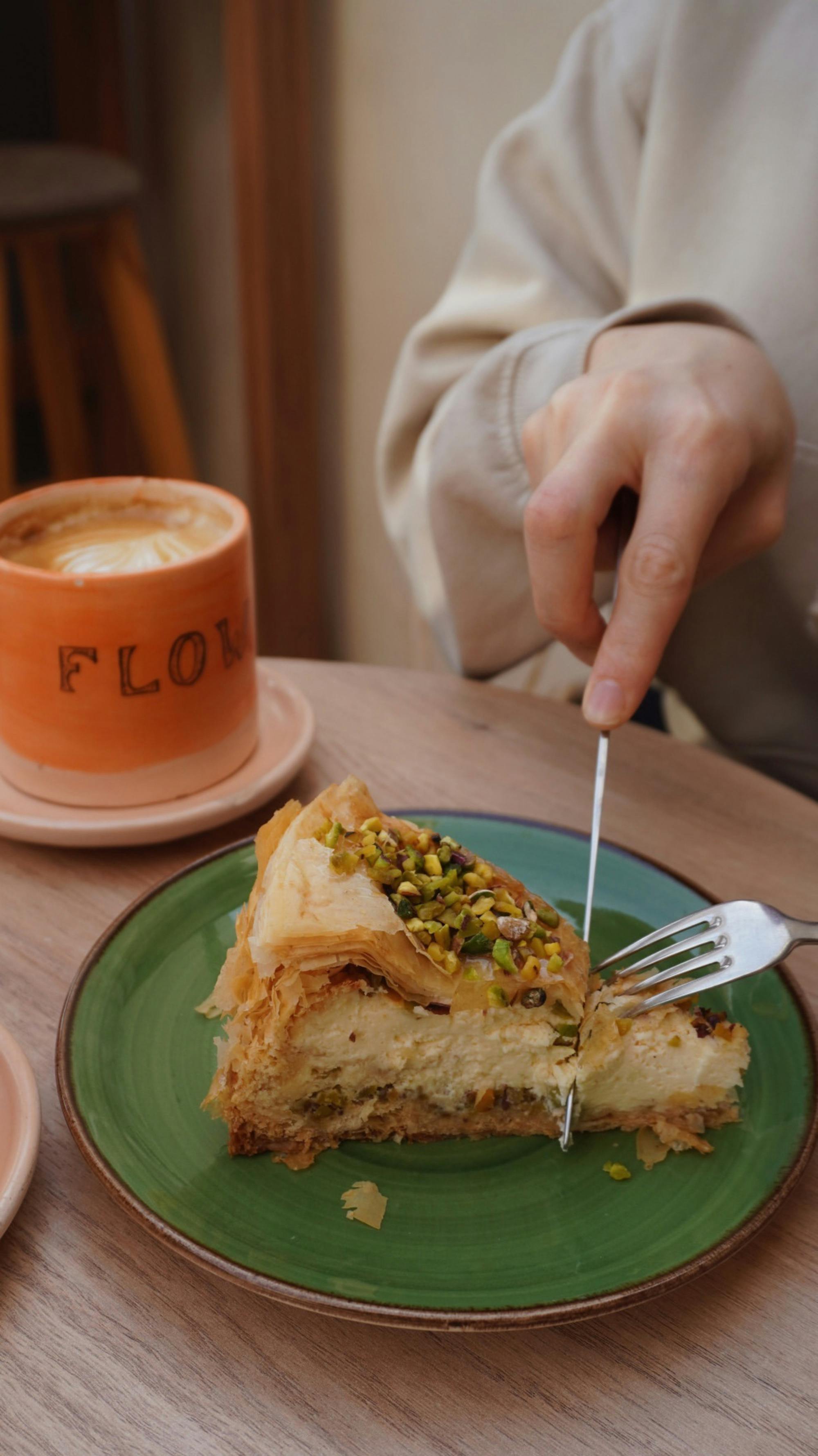 a person eating a piece of cake on a plate