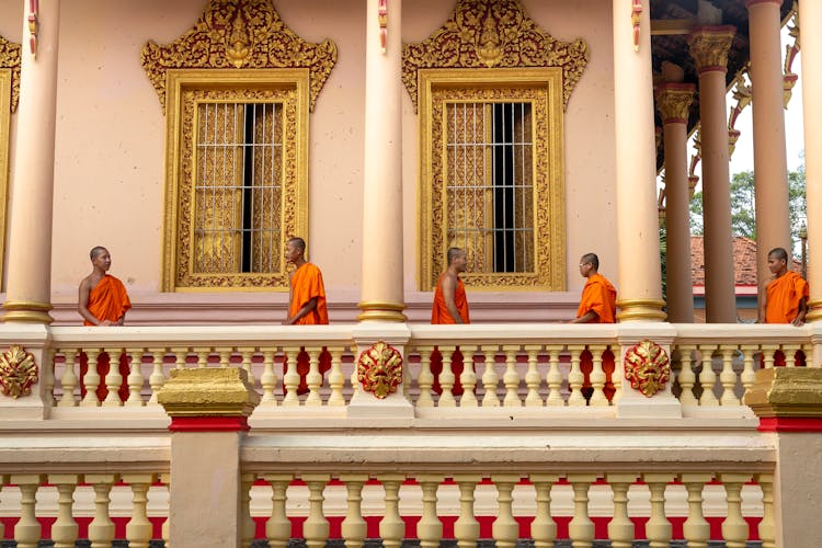 Monks Standing On Porch