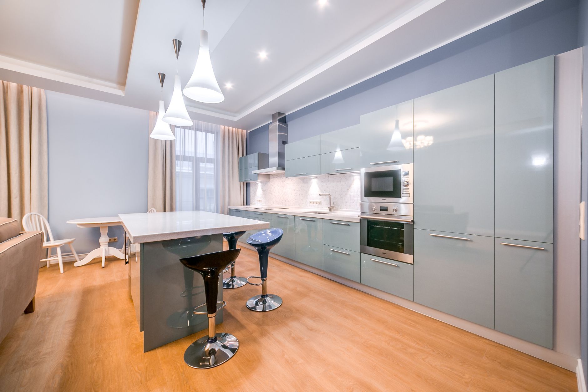 Top Signs Your Home Needs a Remodel in 2025 5 Spacious minimalist kitchen with sleek cabinets and modern lighting.