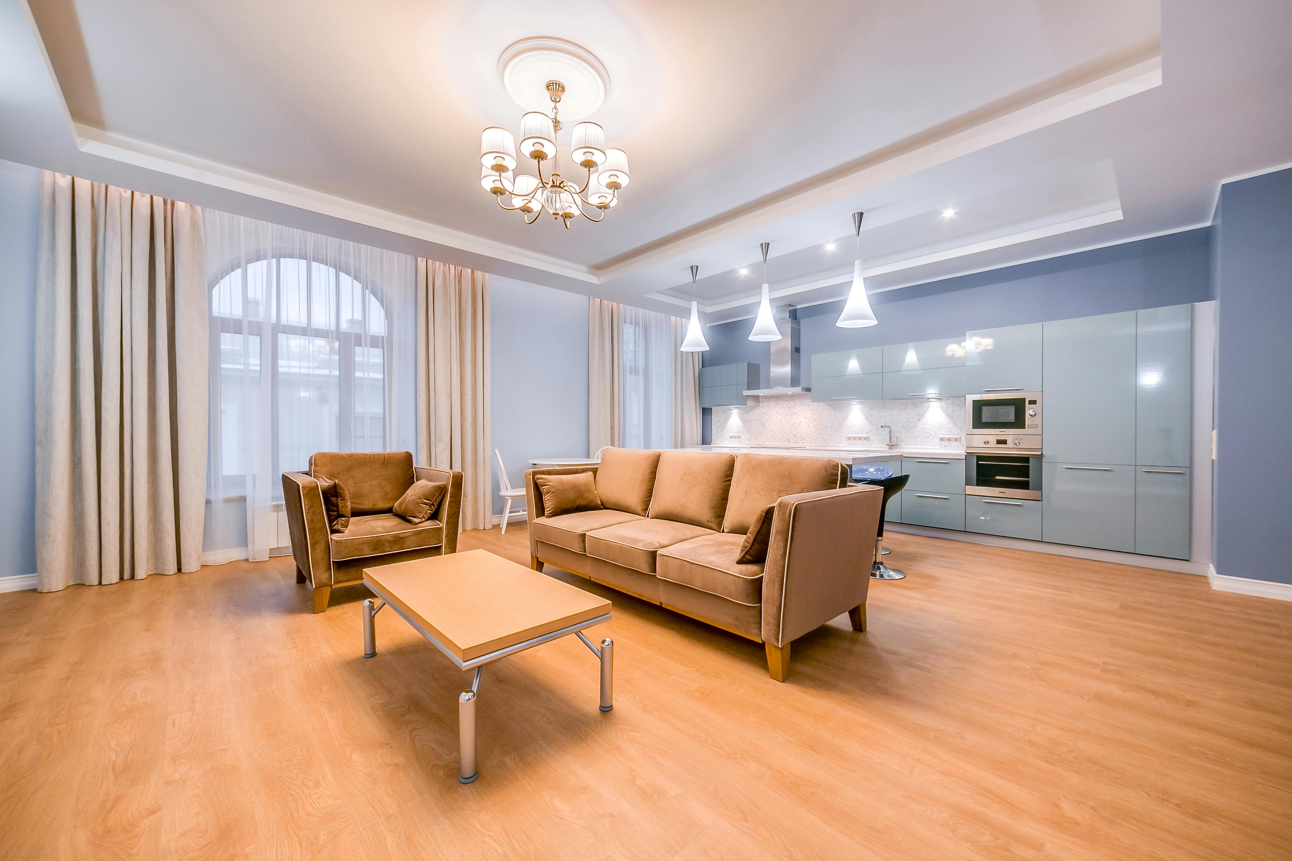 a living room with a couch coffee table and lamp