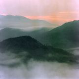 Mist over layered mountains at dawn — photo by Q. Hung Pham on Pexels