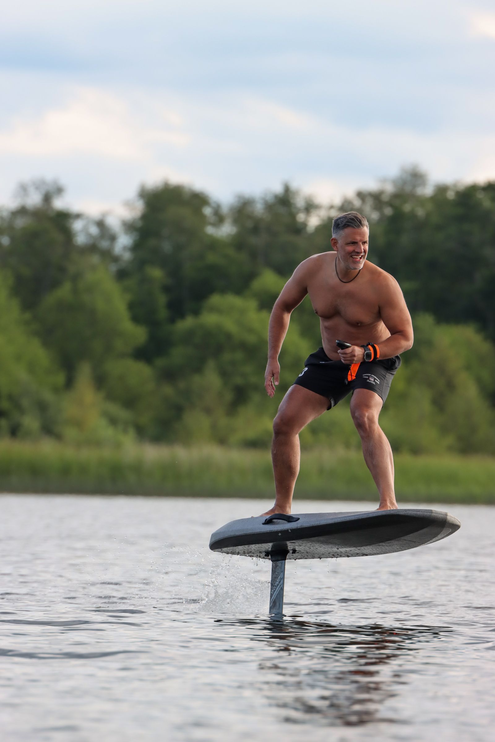 Close-up of a hydrofoil board floating on calm lake water