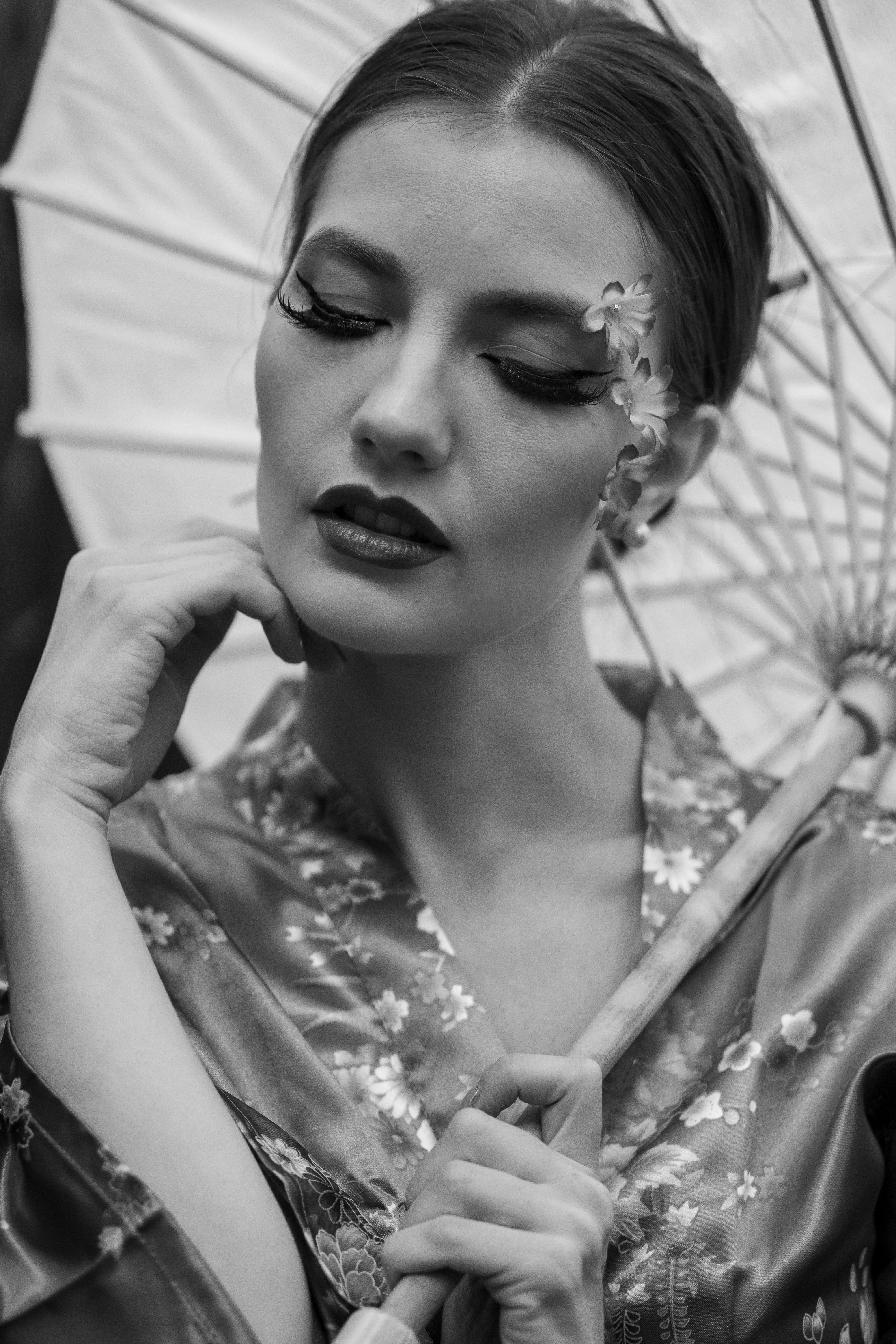 a woman in a kimono holding an umbrella