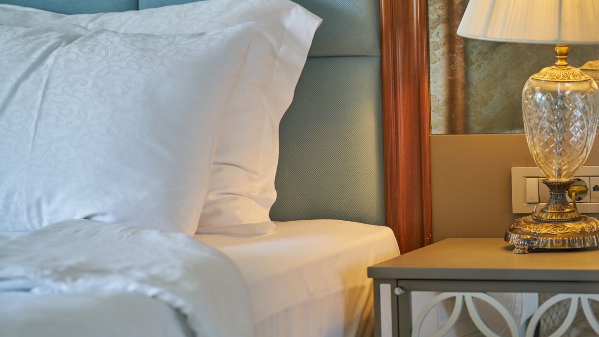 A clean hotel room with a made bed and bright window, the product sold at many prices