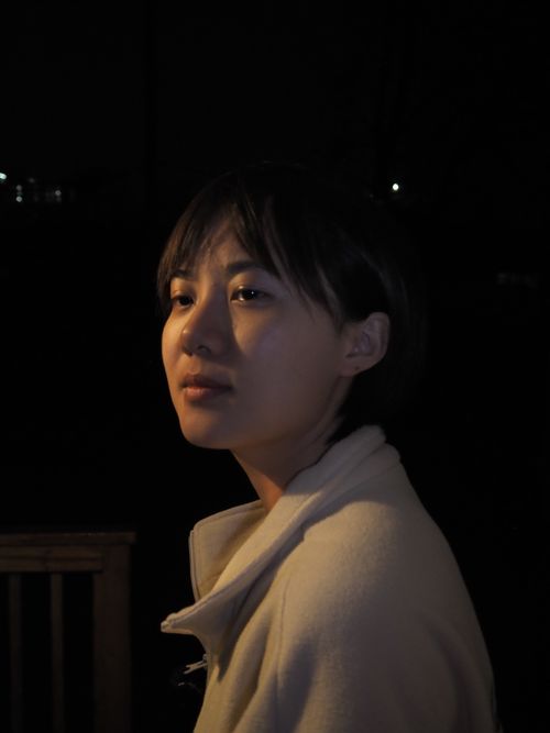 Free A serene portrait of a young woman under soft lighting at night. Stock Photo