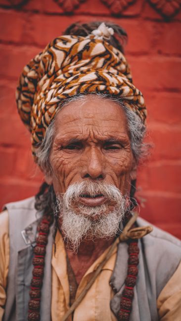 Portrait of an elderly man in traditional attire with a vibrant turban, Kathmandu, Nepal.