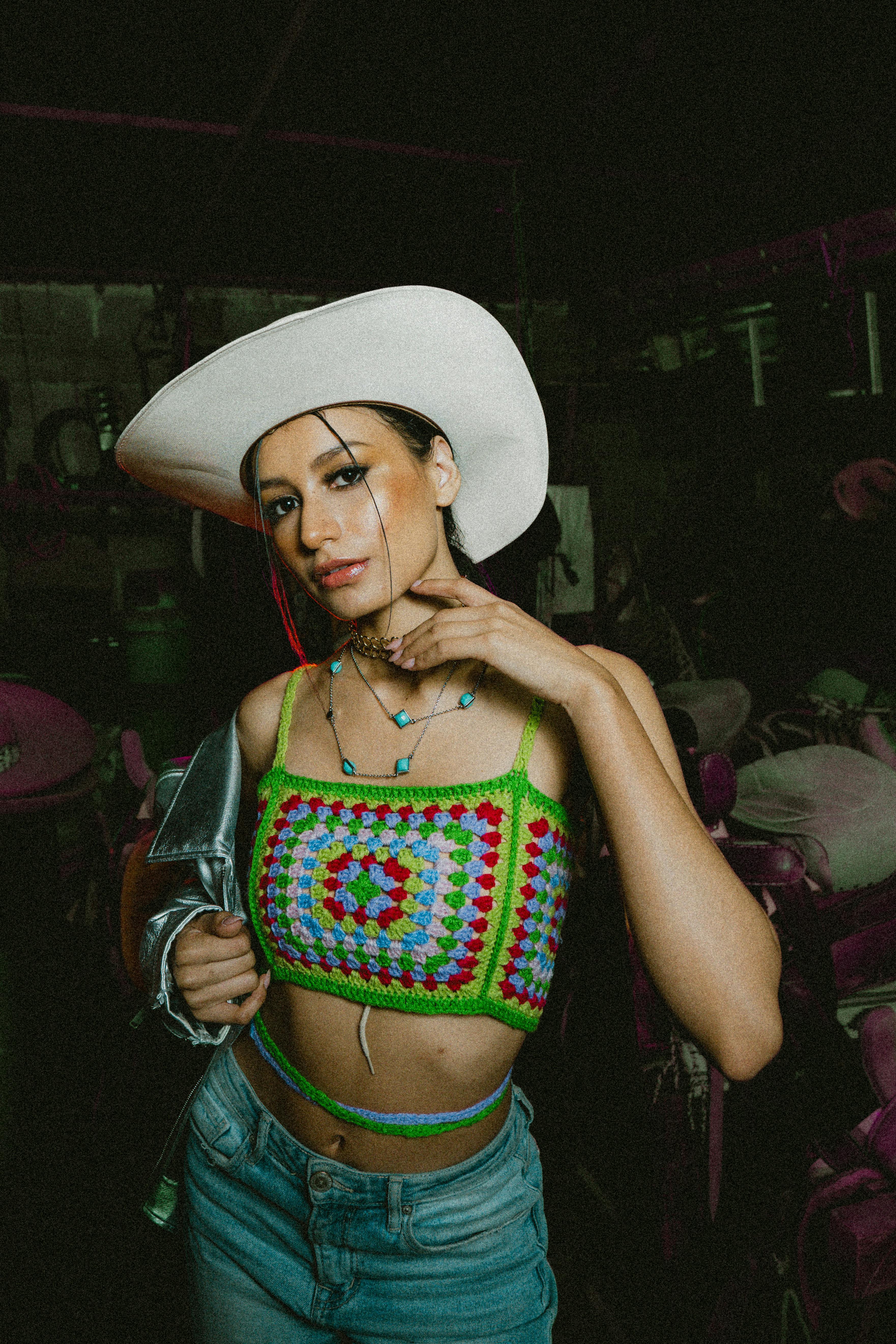 A crocheted top and cowboy hat that echo the DIY codes seen in Harry Styles fan outfits