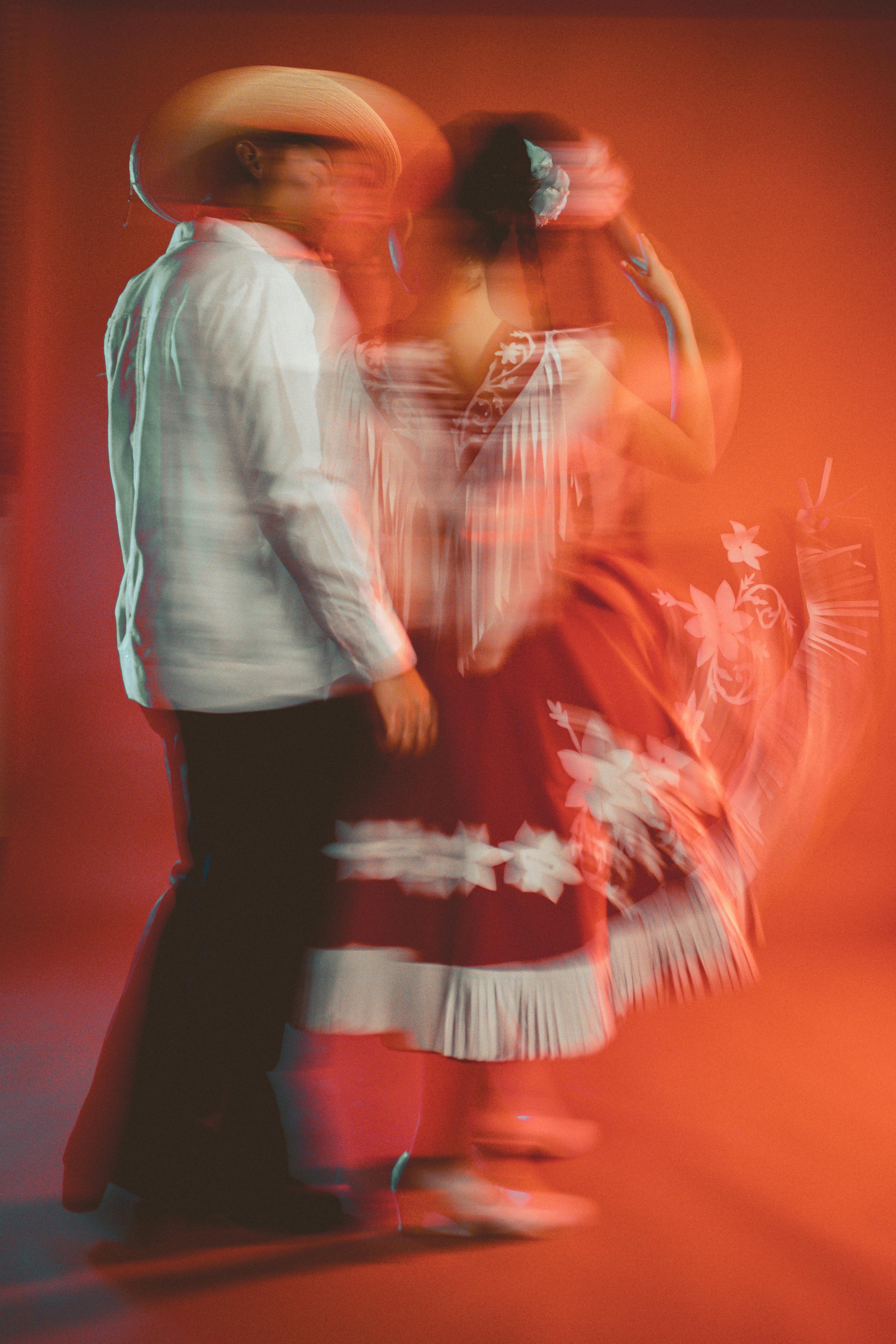 a couple dancing in a mexican style