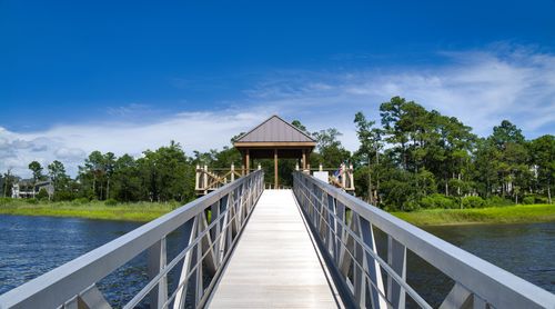 Free Beautiful wooden boardwalk leading to a gazebo over water in Wilmington, NC with lush greenery. Stock Photo