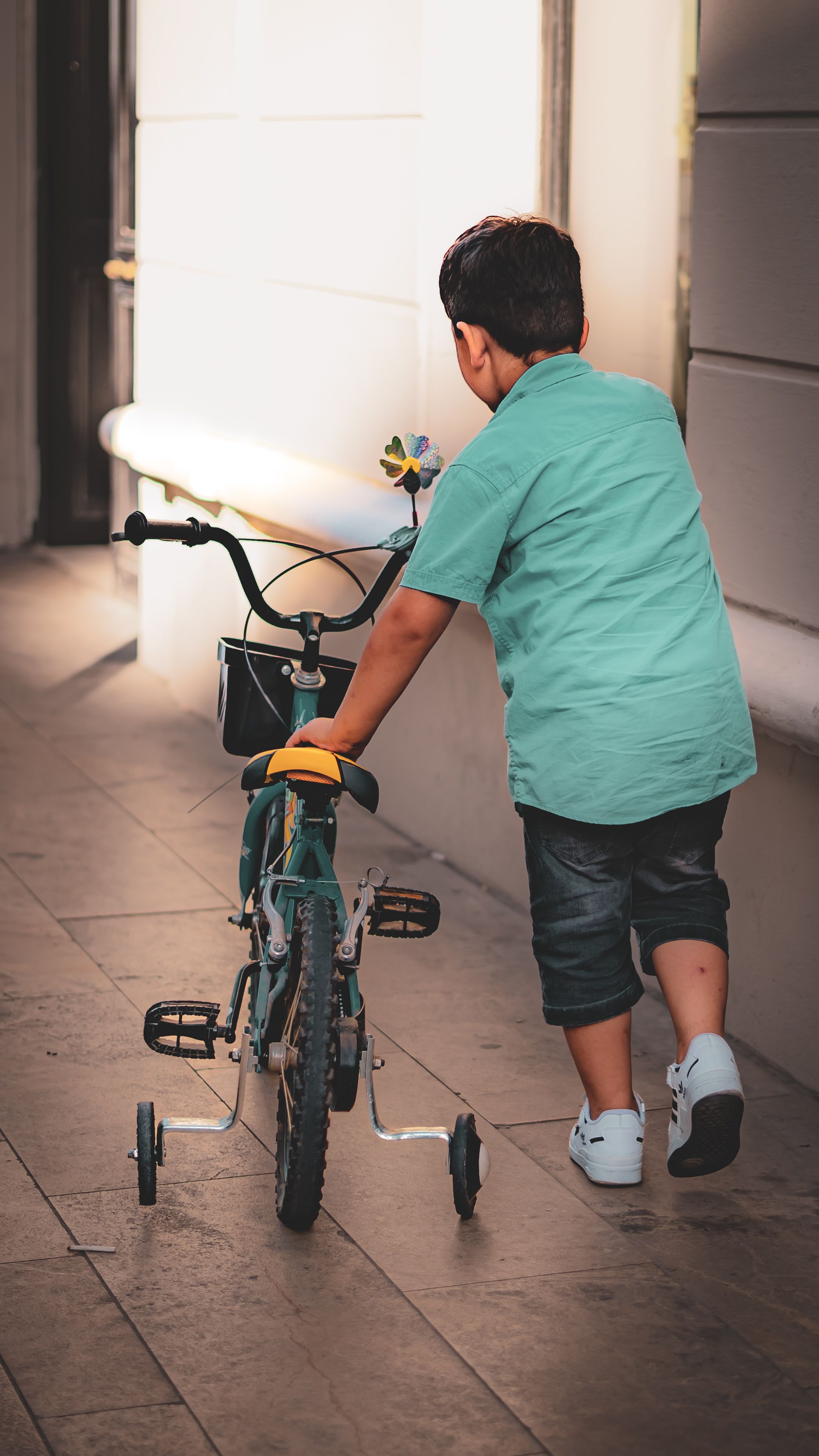 Boy Riding a Bicycle in a City Street · Free Stock Photo