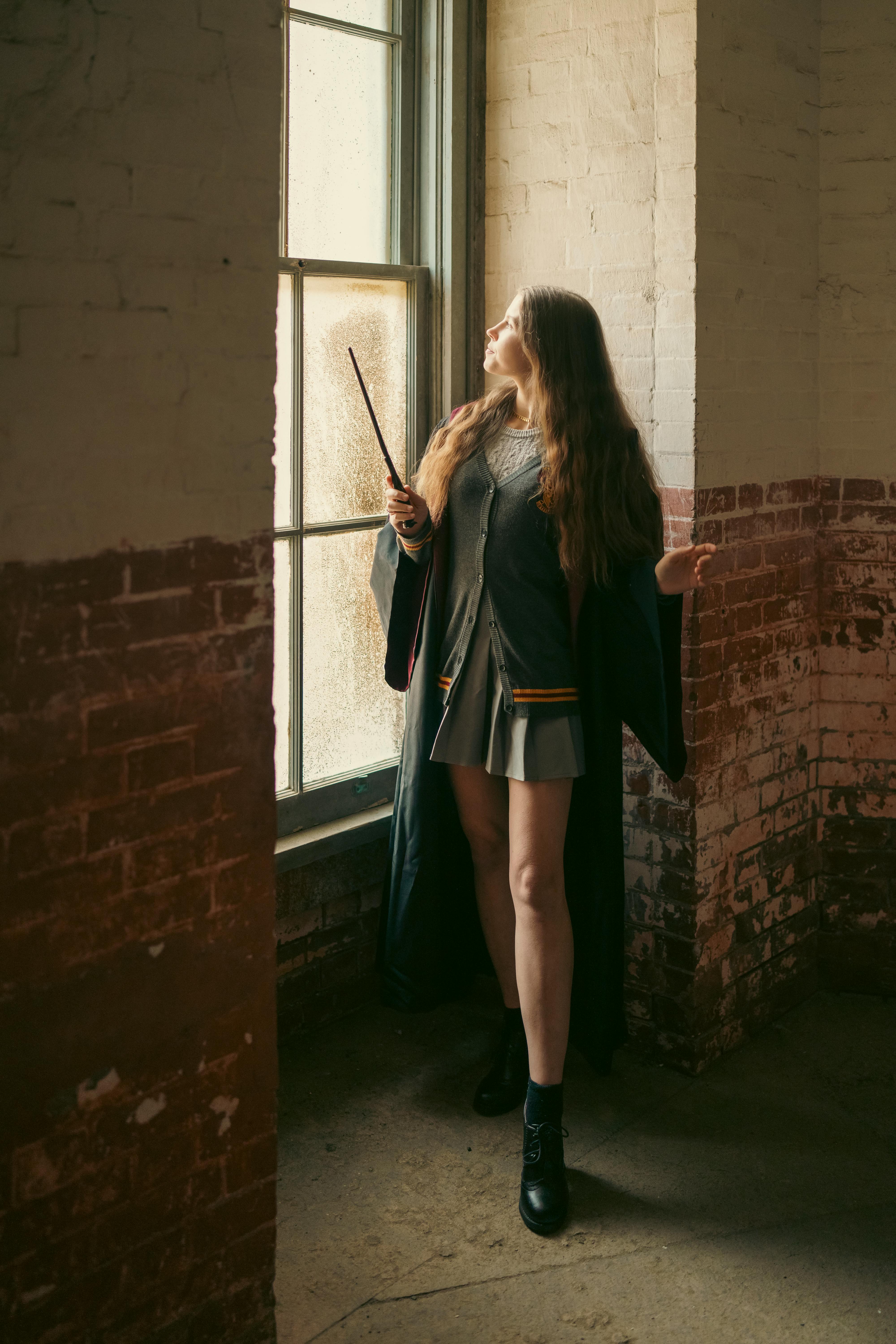 young woman wizard robes wand