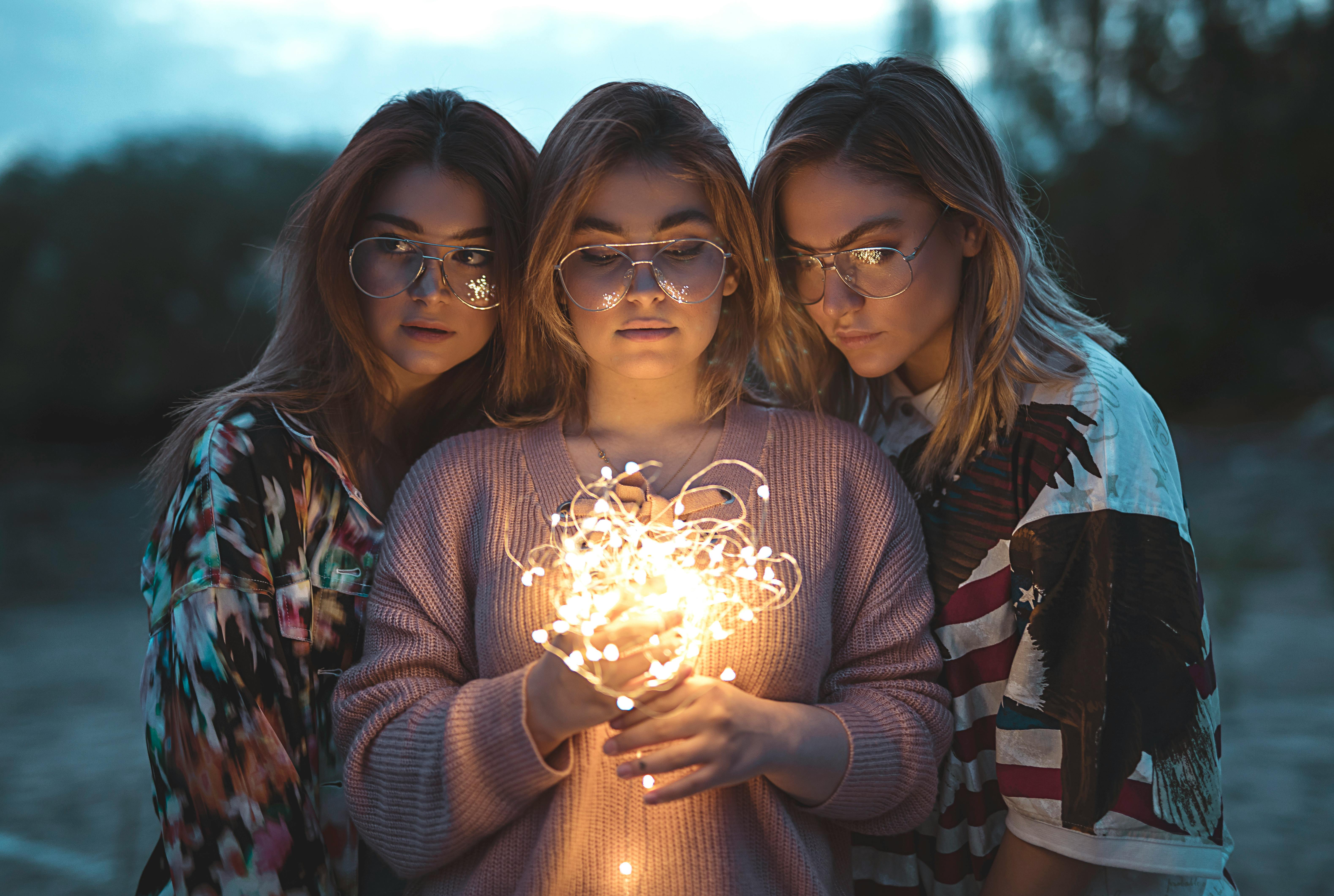 photo of three women wearing eyeglasses