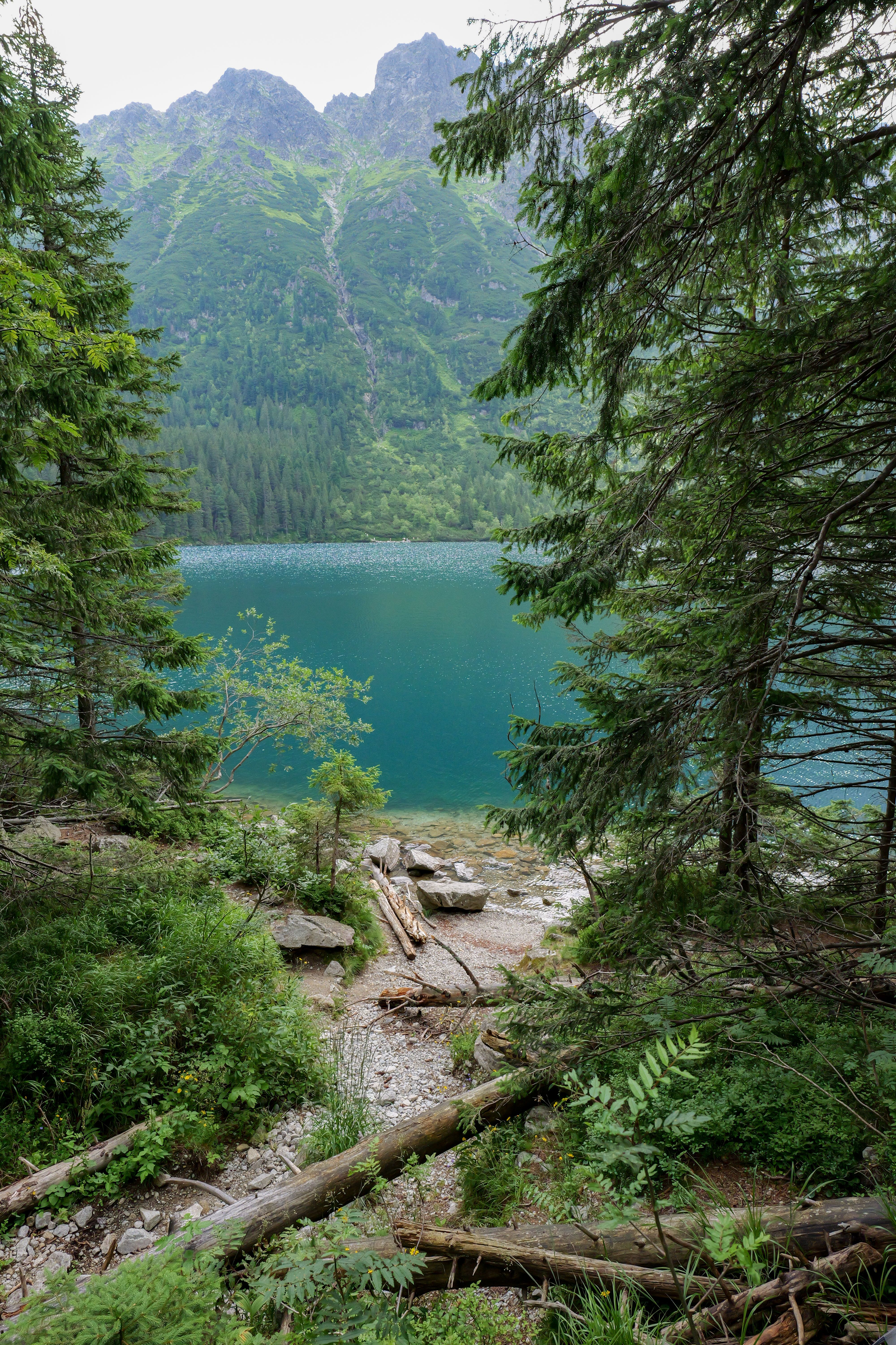 Explore the tranquil beauty of Lake Morskie Oko surrounded by mountains in Zakopane, Poland.