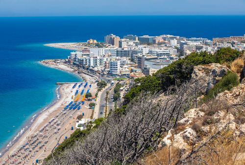 Free Scenic aerial view of a vibrant beachfront city in Rhodes, Greece, highlighting the summer coastline. Stock Photo