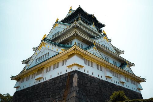 Free A stunning perspective of Osaka Castle, showcasing traditional Japanese architecture under clear skies. Stock Photo