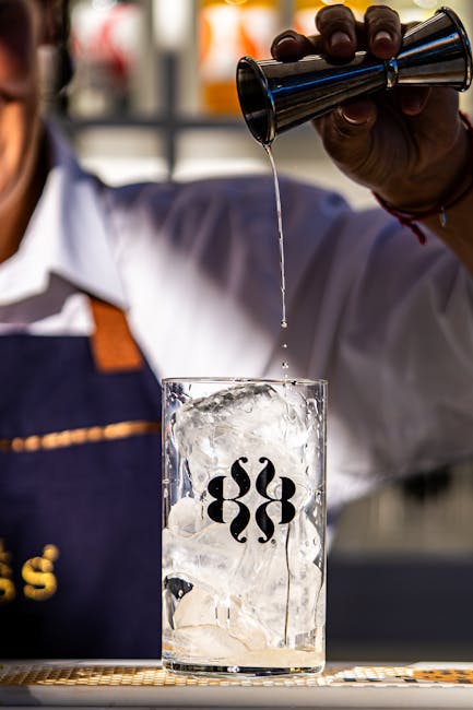 Bartender pouring alcohol representing the need for professional intervention in addiction treatment