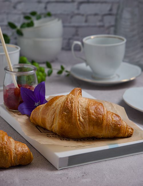 Free Delicious croissants served with fruit jam and tea, perfect for a cozy breakfast setting. Stock Photo
