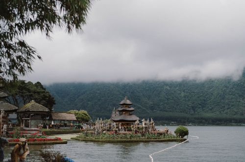 Free A serene view of the Ulun Danu Beratan Temple surrounded by misty mountains and Lake Beratan. Stock Photo