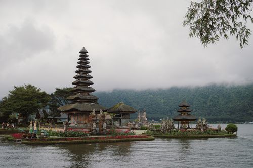 Free Serene landscape of Pura Ulun Danu Bratan temple by the lake in Bali, with misty mountains in the background. Stock Photo