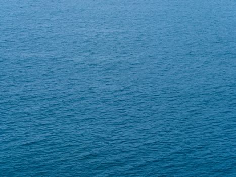 A serene view of the deep blue ocean surface with gentle waves creating a calming pattern.