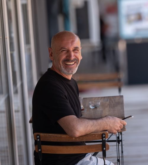 Free A happy man enjoying a sunny day at a cafe in Bornova, İzmir. Stock Photo