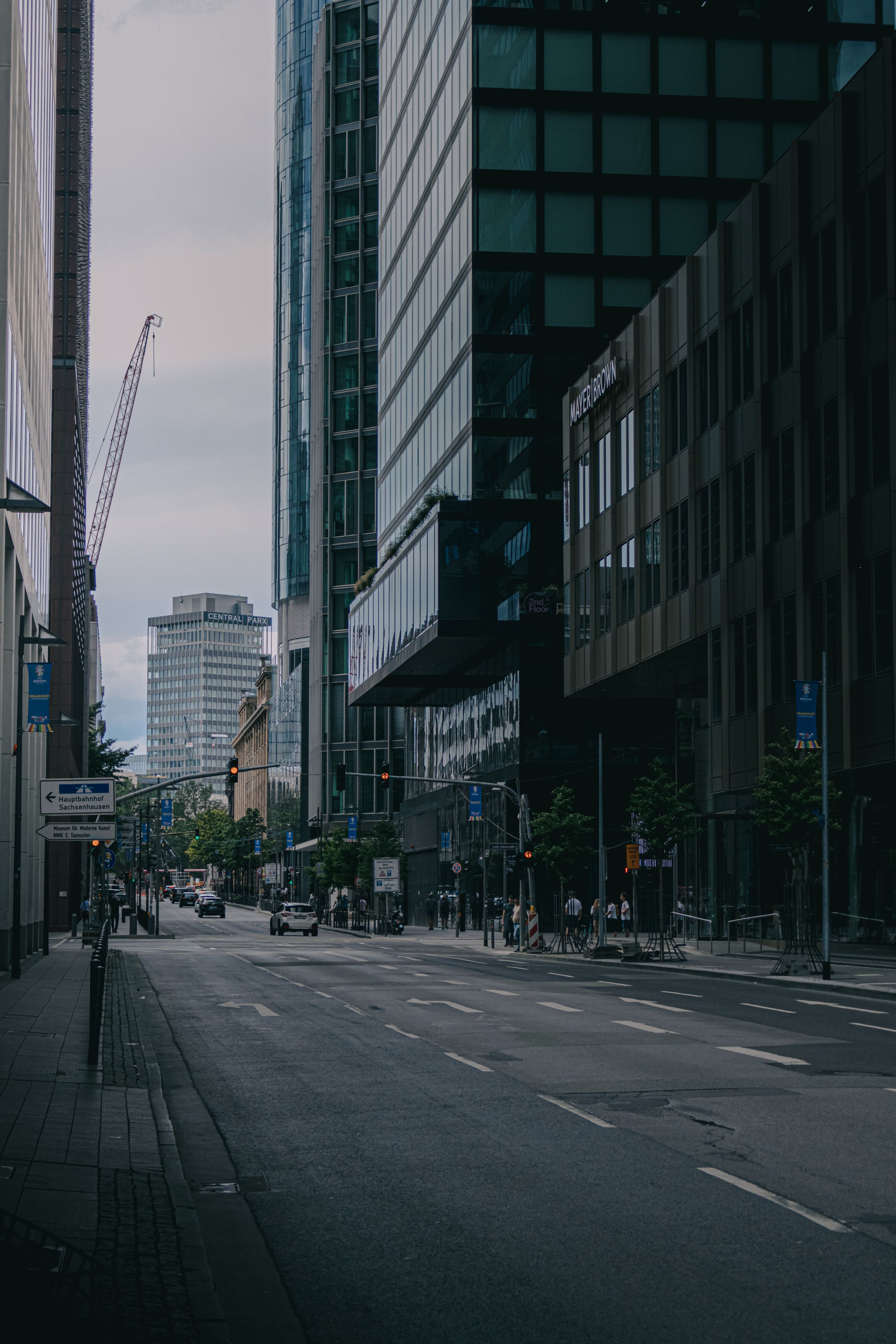A city street with tall buildings and a street light · Free Stock Photo