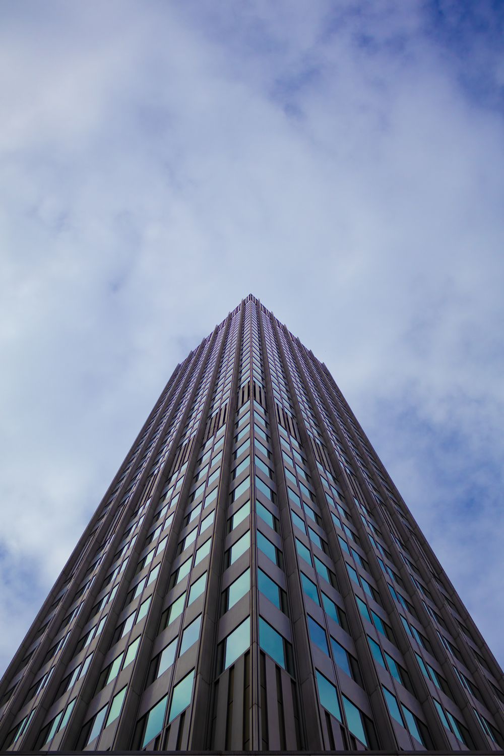 A tall building with windows and a blue sky · Free Stock Photo