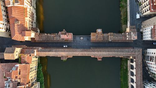 Free Stunning aerial shot of the historic Ponte Vecchio over the Arno River in Florence, Italy. Stock Photo