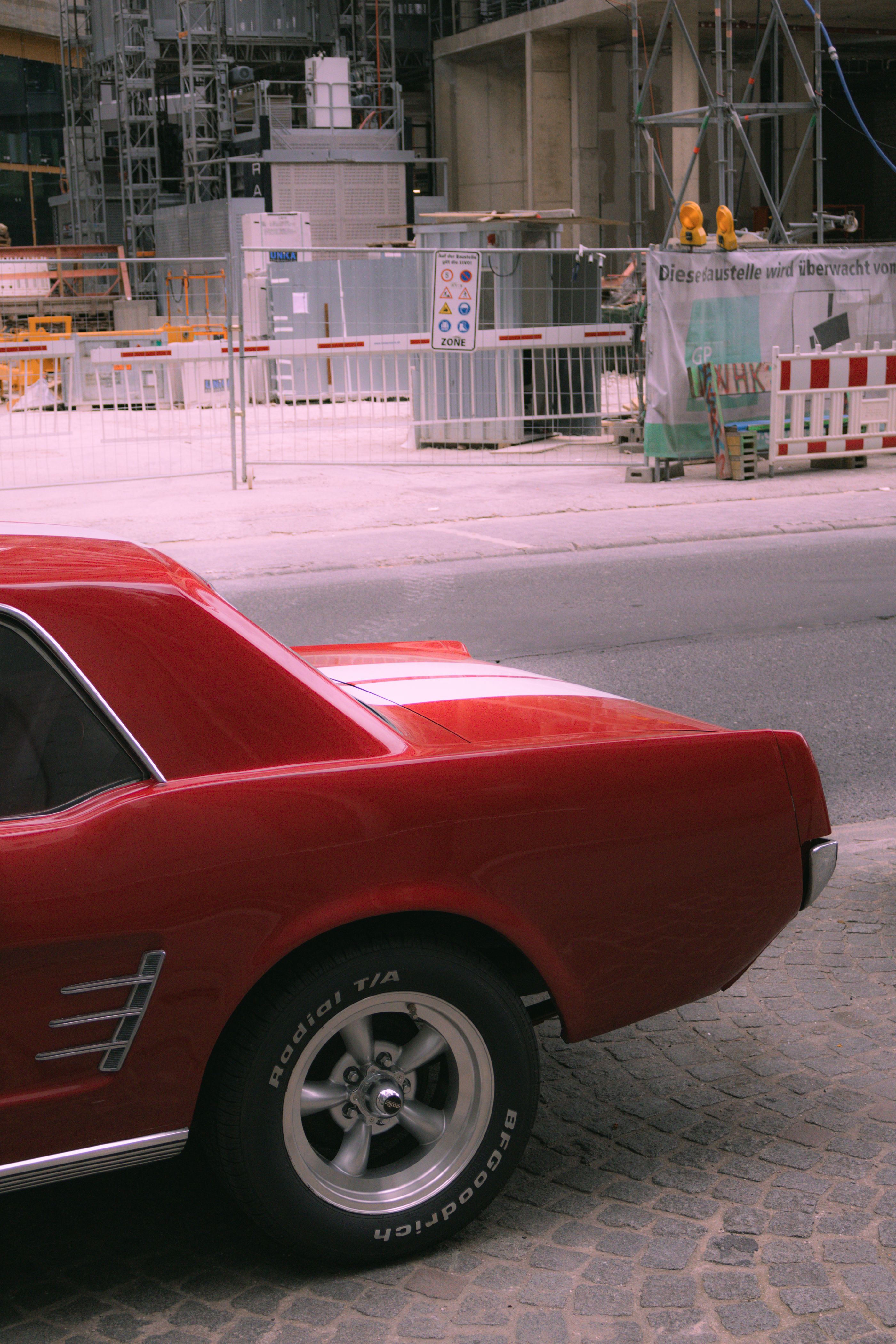 A red car parked on the side of the road · Free Stock Photo